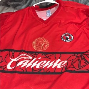 Red shirt sleeve caliente soccer jersey